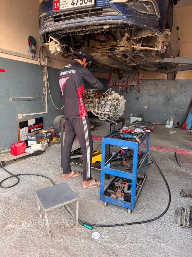 Vehicle suspended on hydraulic lift for brake and suspension repair at Al Muheet Auto